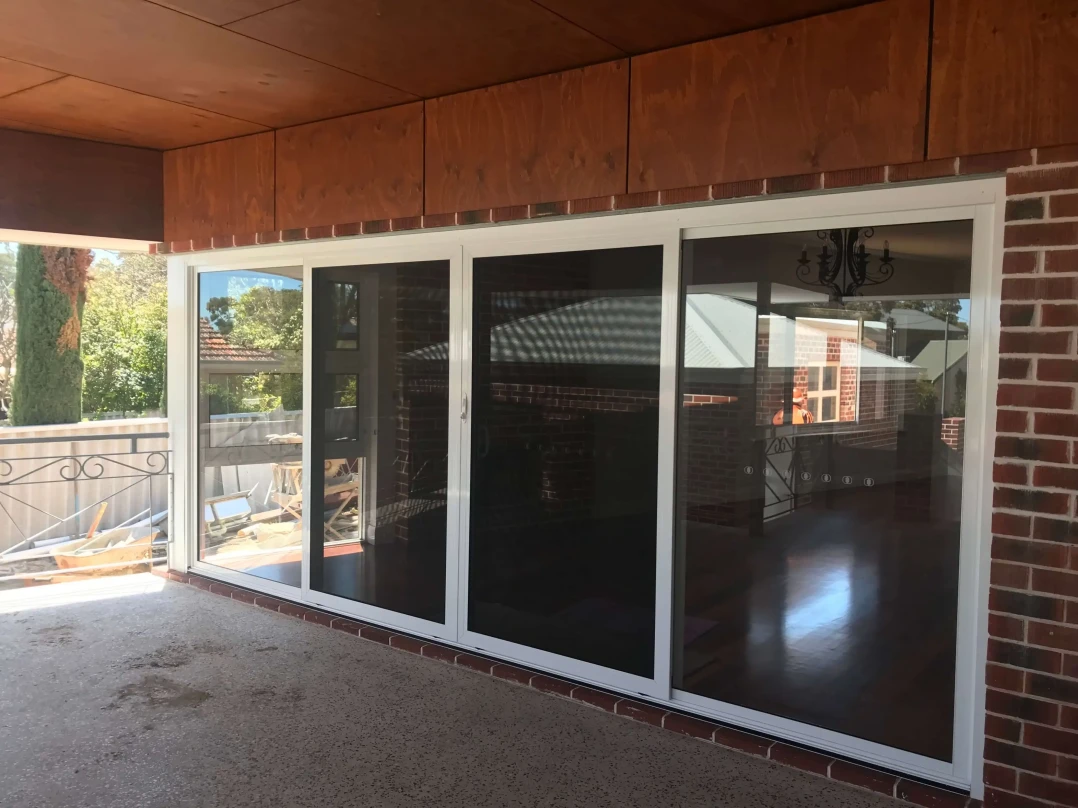 Sliding doors with white aluminium frames.